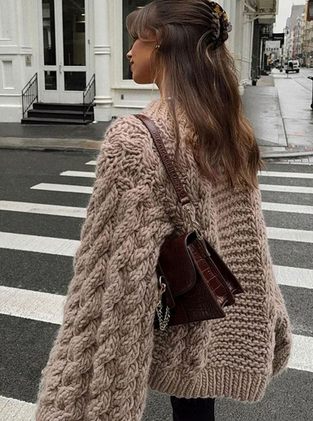 Detalle del punto trenzado grueso del jersey oversize de mujer