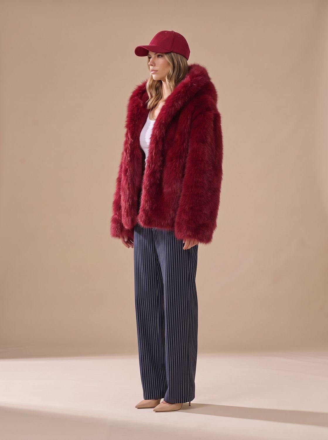 Abrigo oversize con capucha de pelo sintético visto de frente sobre look de invierno